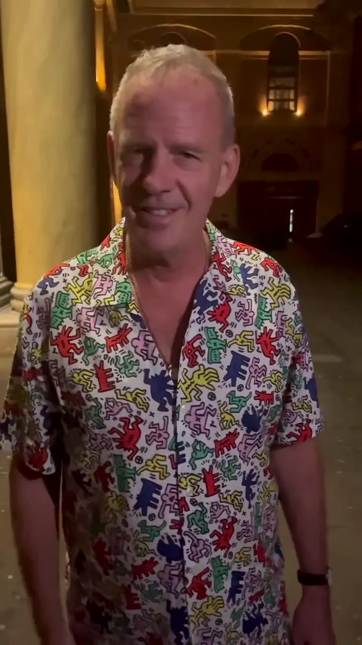 Fatboy Slim in a patterned shirt in a video launching the new EE